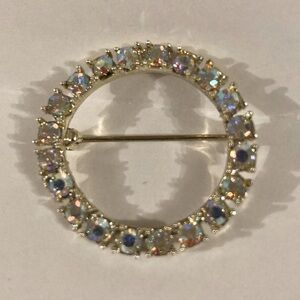 Vintage gold toned circle pin brooch with Aurora Borealis rhinestones